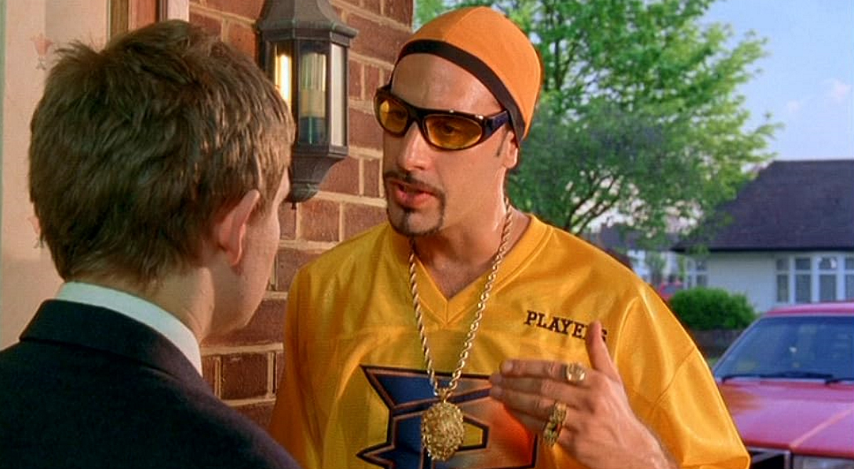 Обложка: кадр фильма «Али Джи в парламенте» (2002)